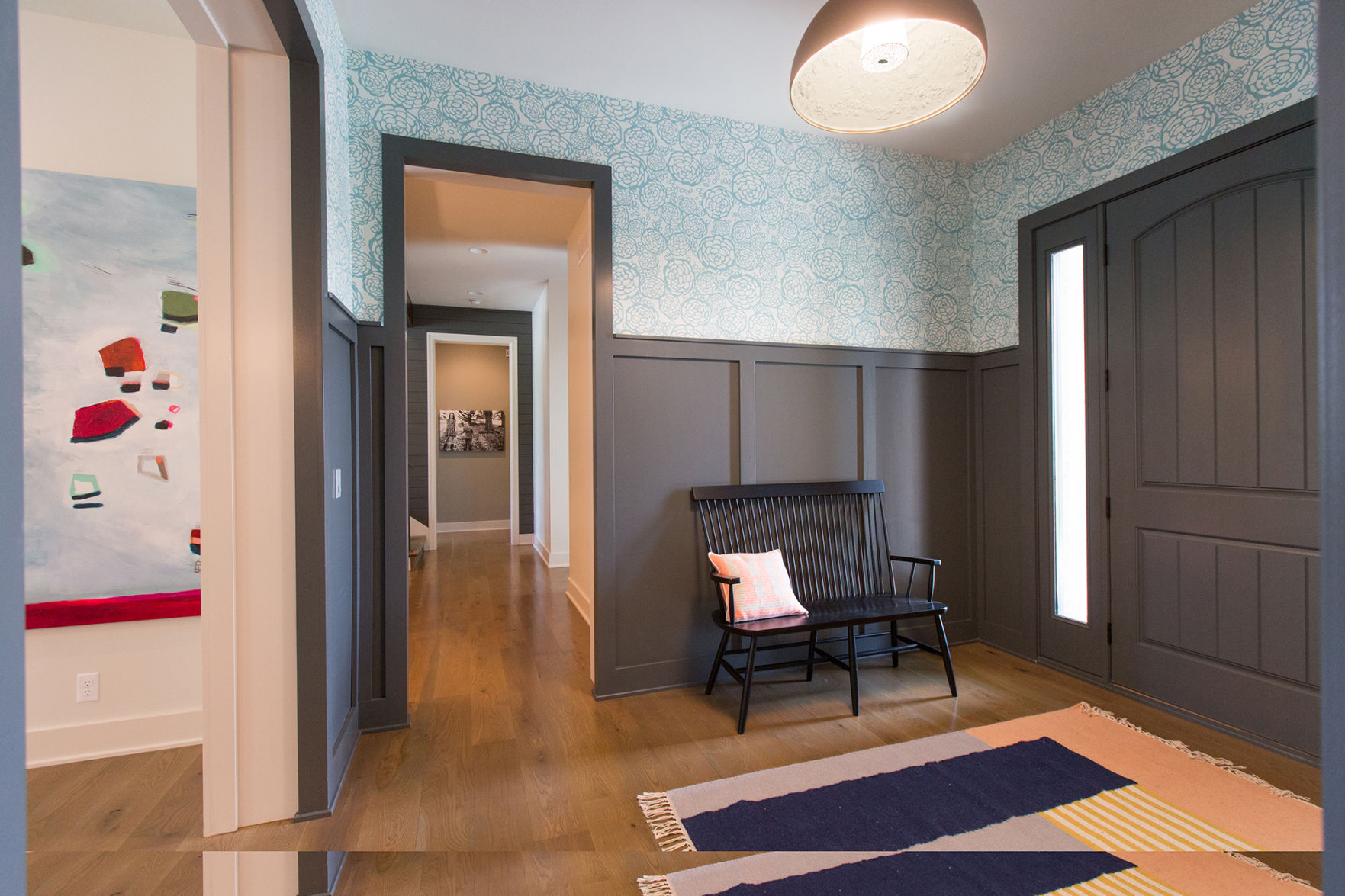 "I knew I wanted a defined entry space,” says this Omaha homeowner. “The paneling gives it a sense of formality.” She found the bench from Schoolhouse Electric and the lighting fixture from Dwell.